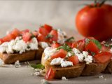 Italian Appetizer Bruschetta with roasted tomatoes, cheese and herbs