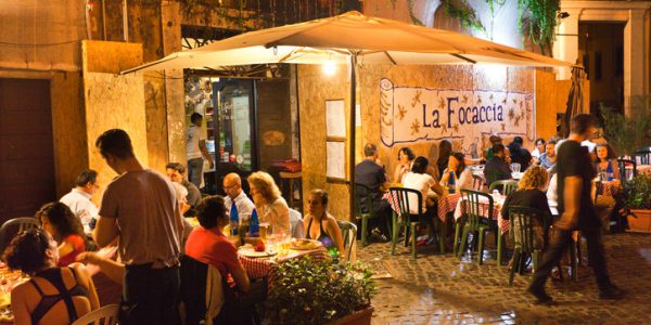 Rome, Italy - Sep 16, 2015: Tourists and local residents enjoying the night life, dining in outdoor street restaurants in the center of Rome, Italy.