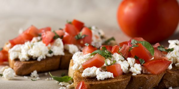 Italian Appetizer Bruschetta with roasted tomatoes, cheese and herbs
